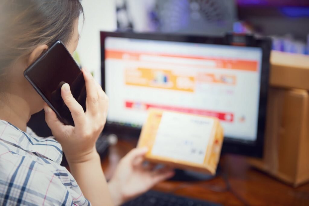 Crafting Captivating Headlines: Your awesome post title goes here Woman multitasking by using a phone and checking an online purchase package at home.